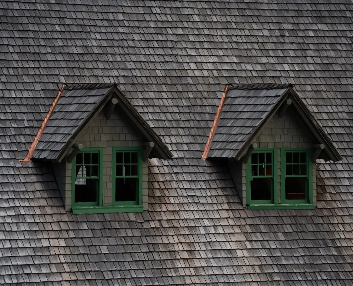Dormers on a shingle roof in Topeka, KS, where step flashing and kickout flashing carry water past the walls